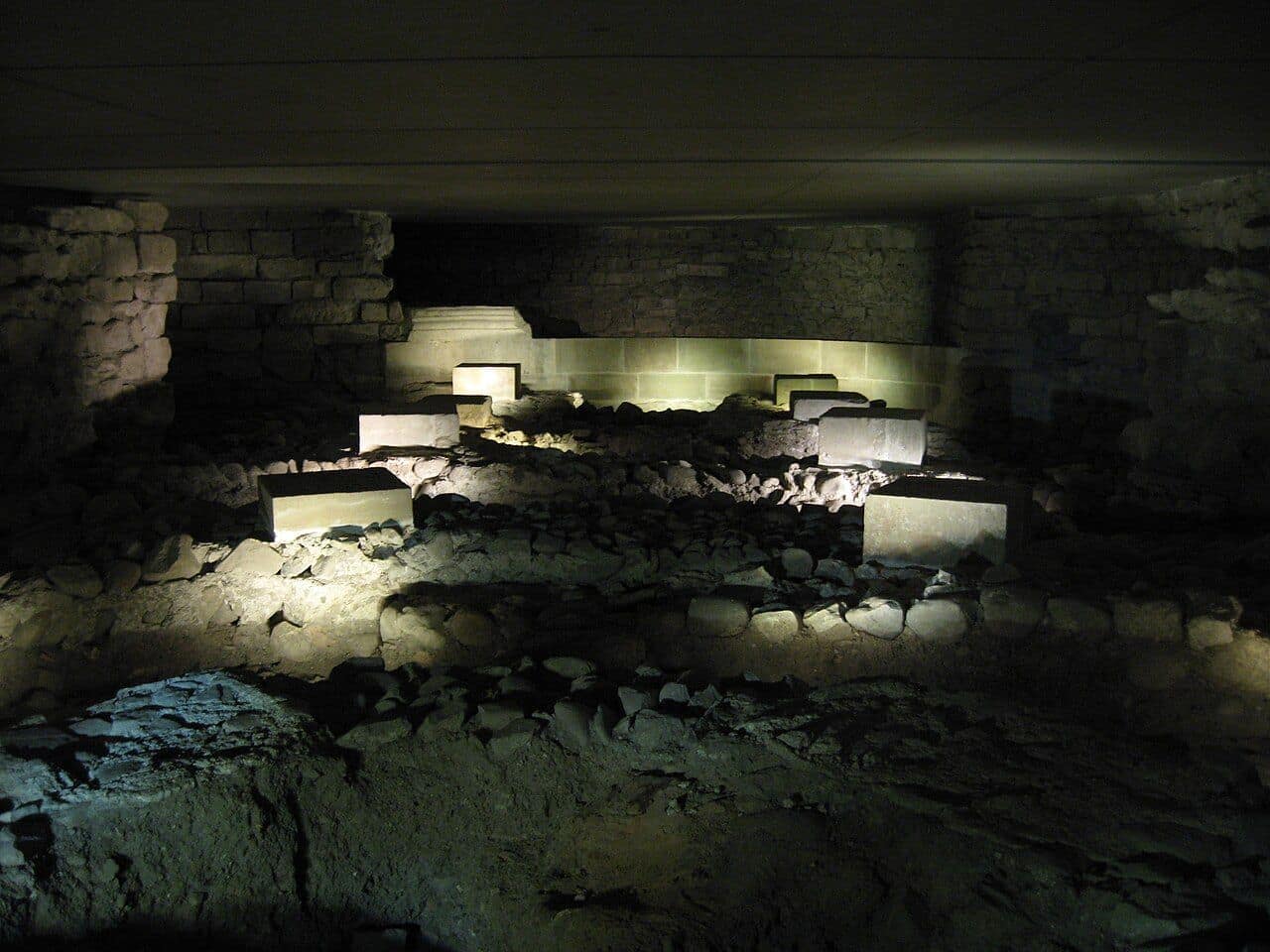 Lit remains in the archaeological site beneath St Pierre Cathedral in Geneva, ancient walls and successive floors