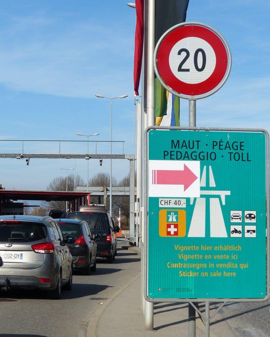 The Bardonnex motorway border crossing between France and Switzerland, with queues of cars at the customs booths