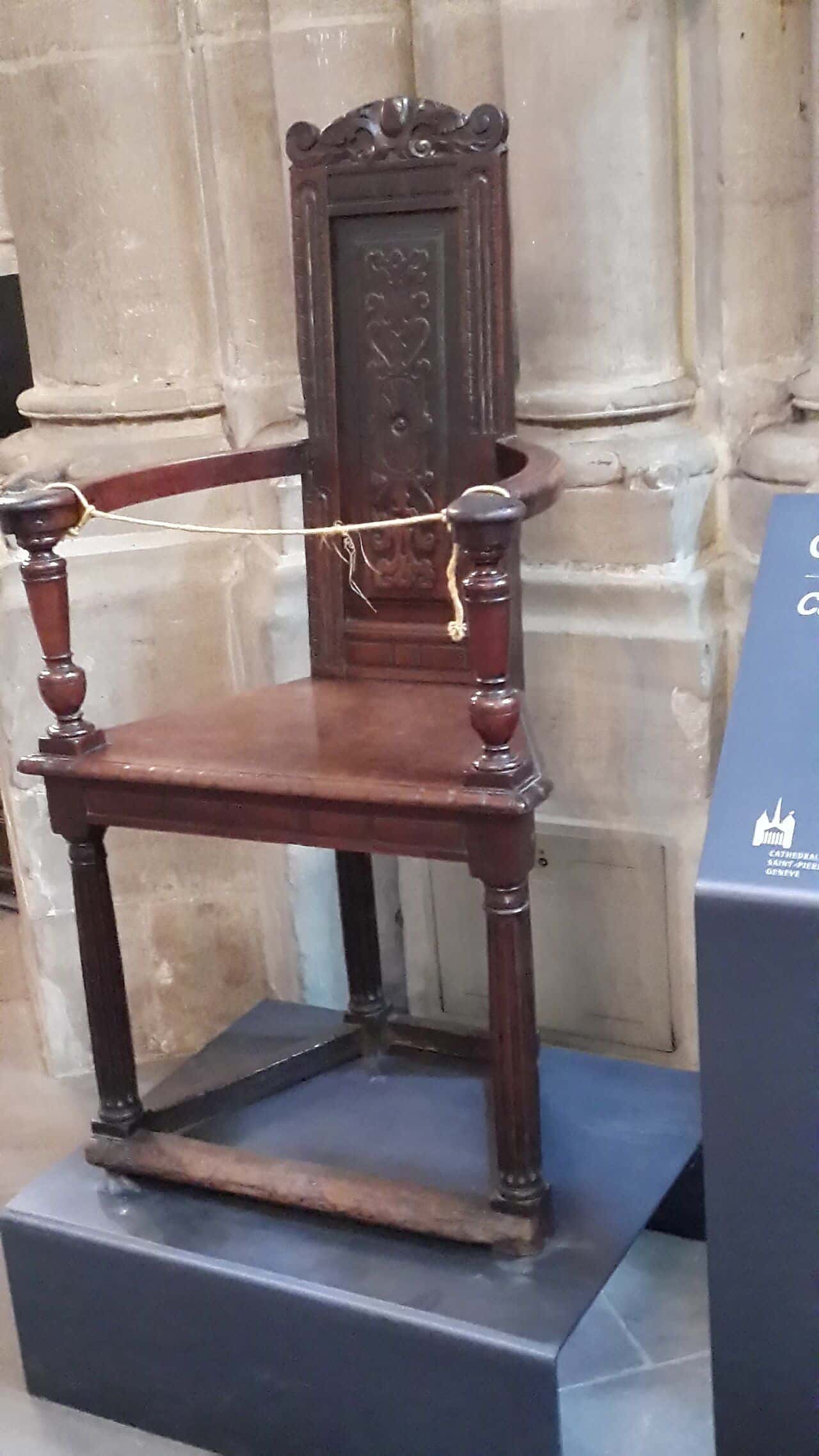 The wooden chair traditionally associated with John Calvin, on display in the nave of St Pierre Cathedral in Geneva
