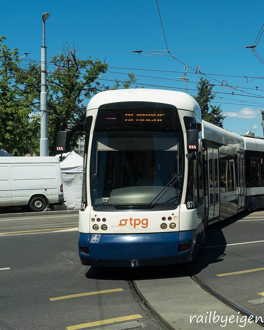 A tpg tram crossing the Plainpalais district in Geneva, with passengers at the stop